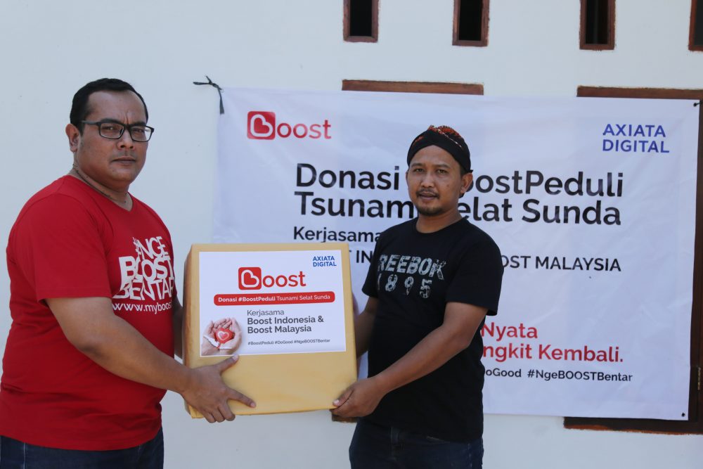 Penyerahan Barang Bantuan BoostPeduli Untuk Warga Sekitar Salah Satu Posko Pengungsian Oleh Yakaja Muhainudin Kisti Selaku Regional Operation Head Jabotabek dan WJ Banten Boost Indonesia min e1547604697553